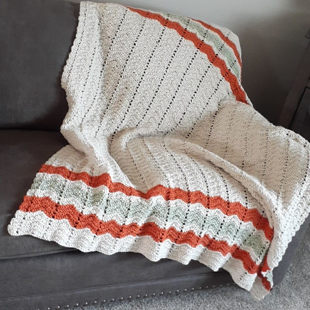 Beautiful hand crocheted 50" X60"taupe afgan accentedw/soft green & Terra cotta.